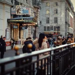 London's West End at dusk, with glowing Criterion theatre marquee, setting the scene for a memorable pre and post theatre dinner in London at Aki London on Cavendish Square