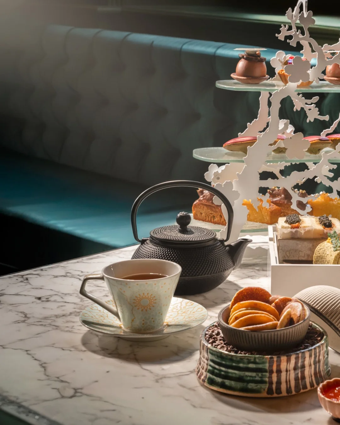 Japanese tea service with cast-iron teapot, teacup and afternoon tea stand at Aki, Marylebone